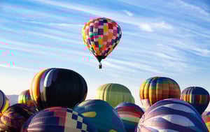 Hot air balloons with one above all others.
